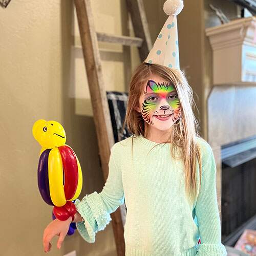 girl holding balloon parrot