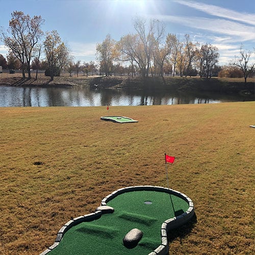 portable mini golf outdoors near pond