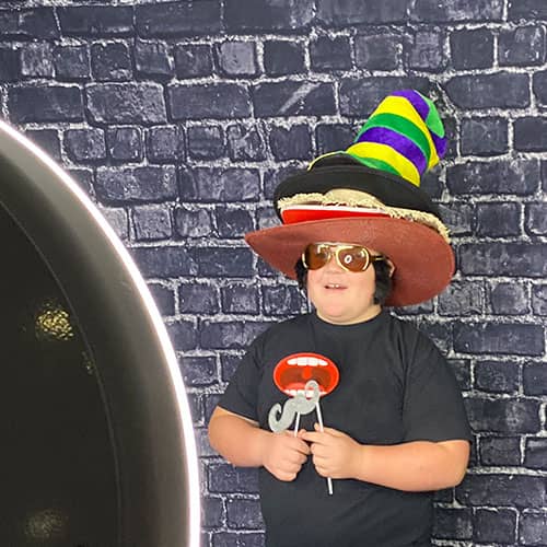 boy wearing props at photobooth